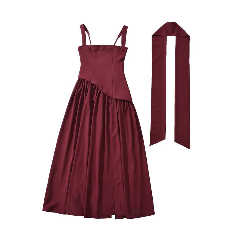 Burgundy satin midi dress with thin straps, asymmetrical waist, and matching sash for elegant occasions