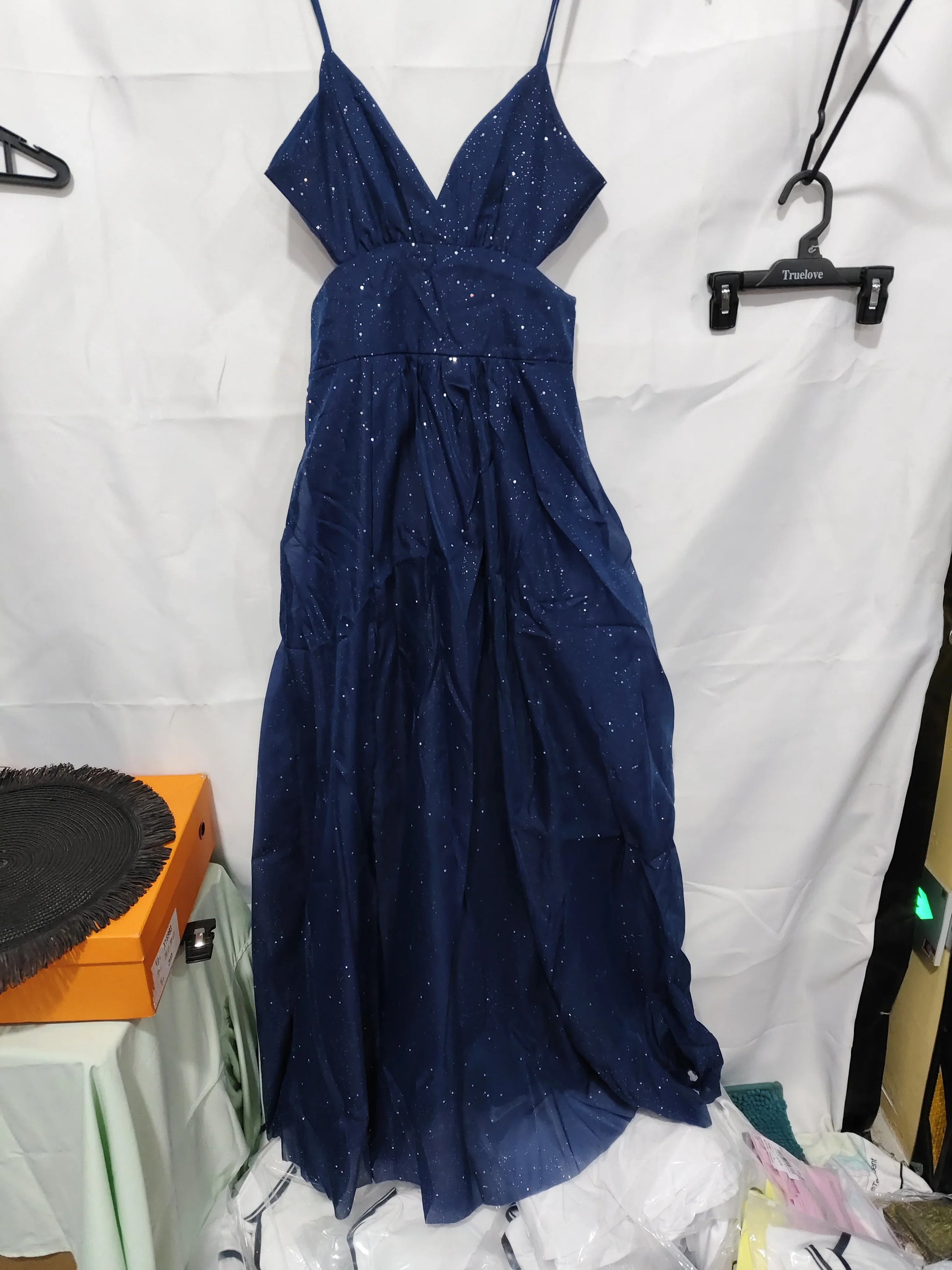 Navy blue sparkly maxi dress with V-neck and thin straps, ideal for evening events or parties