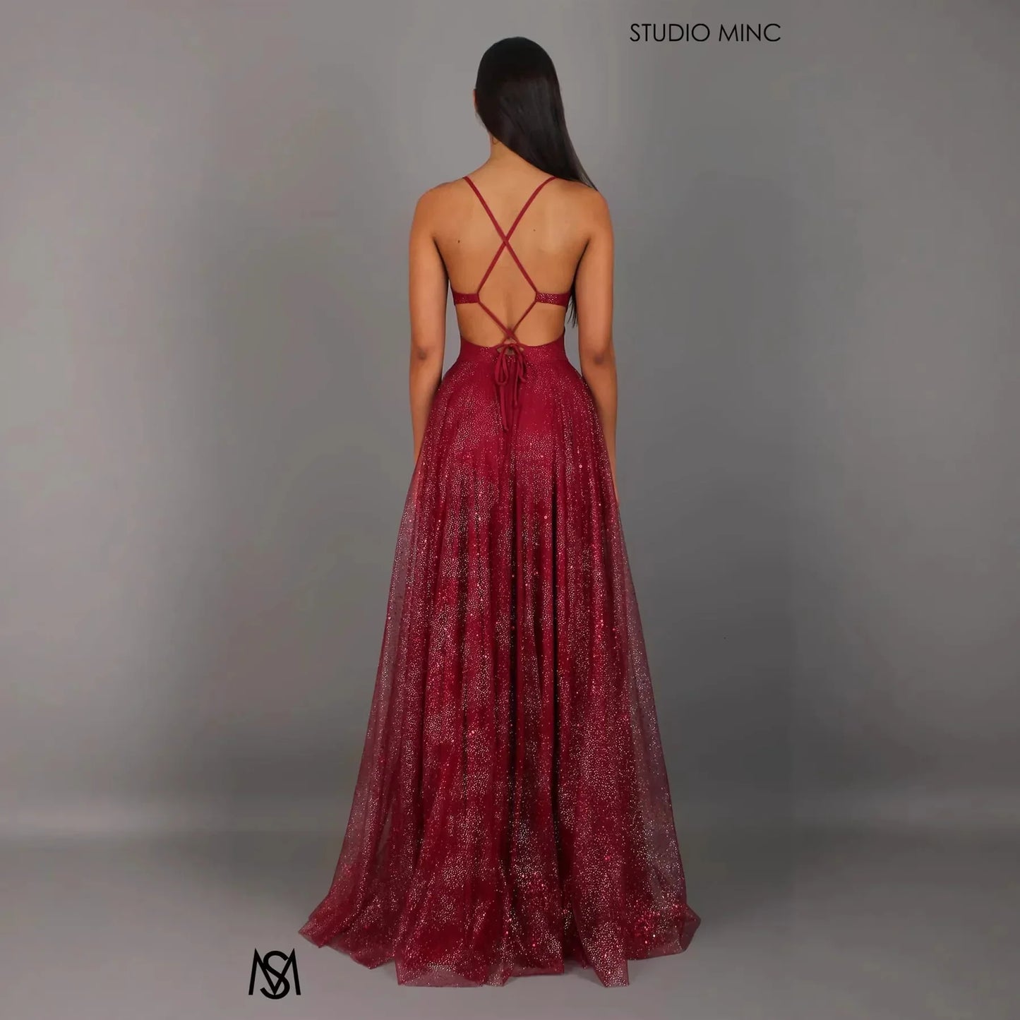 Burgundy glitter maxi dress with crisscross back straps and open back design, perfect for evening events