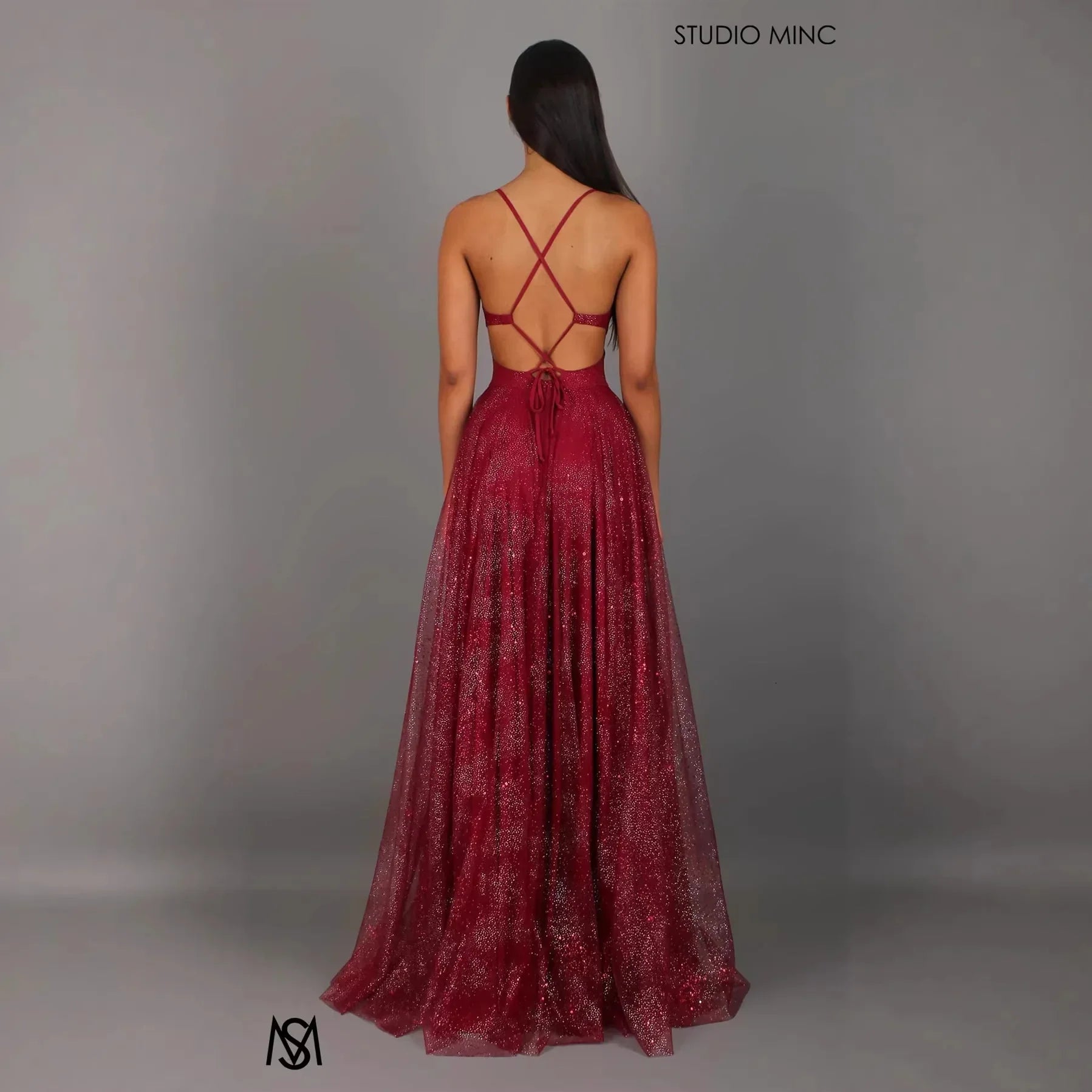 Burgundy glitter maxi dress with crisscross back straps and open back design, perfect for evening events
