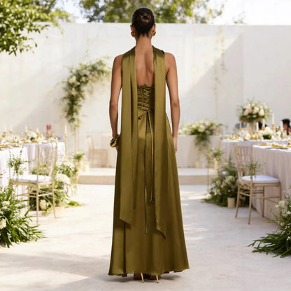 Olive green satin maxi dress with lace-up back and draped halter neckline, perfect for wedding guest or formal events