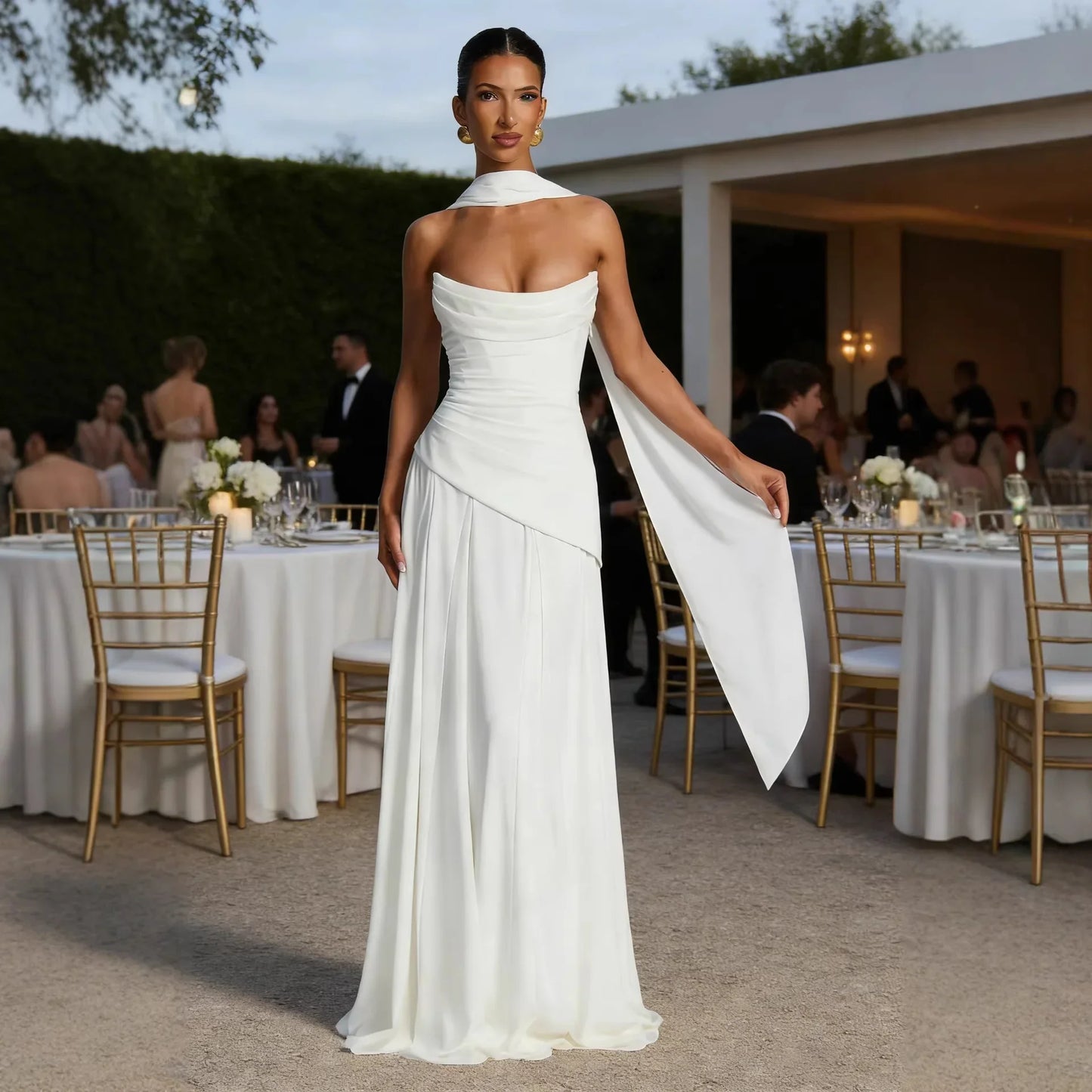 Elegant white strapless wedding gown with draped neckline and flowing cape, perfect for formal bridal events