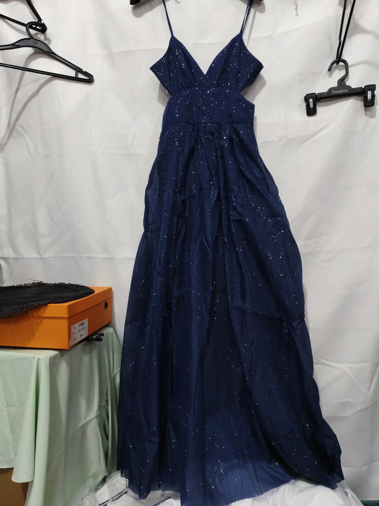 Navy blue sparkly maxi dress with V-neck and tiered ruffle skirt, ideal for evening events or parties