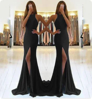 Black mermaid evening gown with high slit, halter neckline, and flowing train for formal events