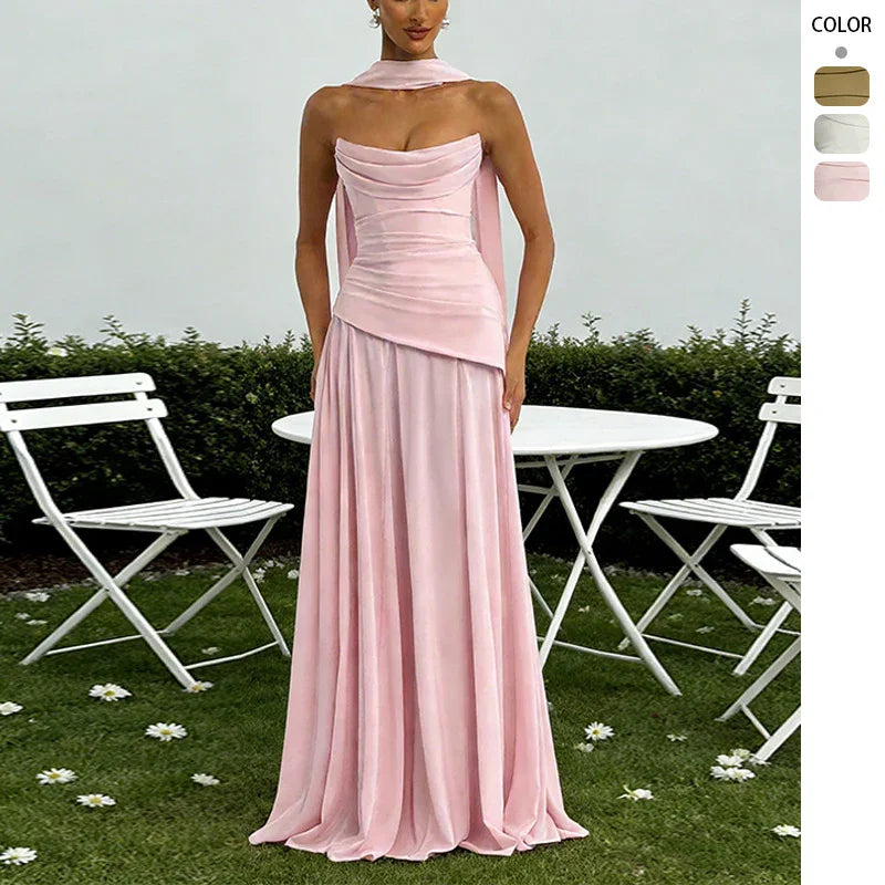 Elegant pink velvet strapless evening gown with draped bodice and flowing floor-length skirt, perfect for formal events