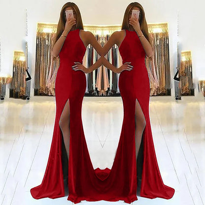 Red satin mermaid evening gown with high slit and halter neckline, perfect for formal events and prom