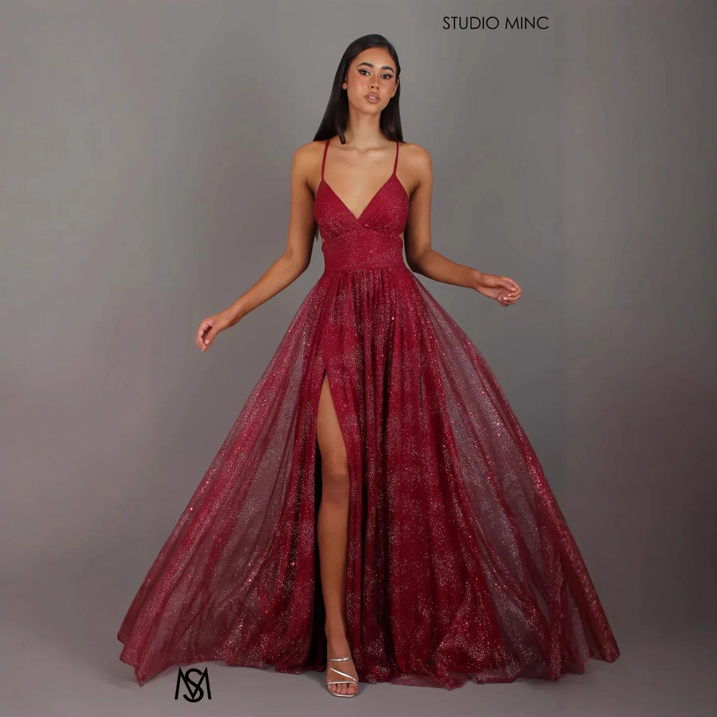 Burgundy glitter A-line prom dress with V-neck, spaghetti straps, and high slit, perfect for formal events and evening wear.
