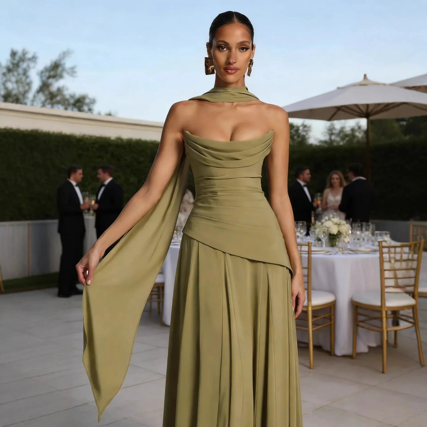 Olive green strapless evening gown with draped neckline and flowing cape, perfect for formal events and weddings
