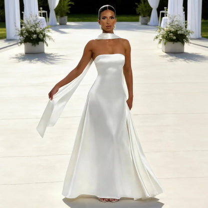 White satin strapless wedding dress with high collar and flowing cape, perfect for modern bridal elegance