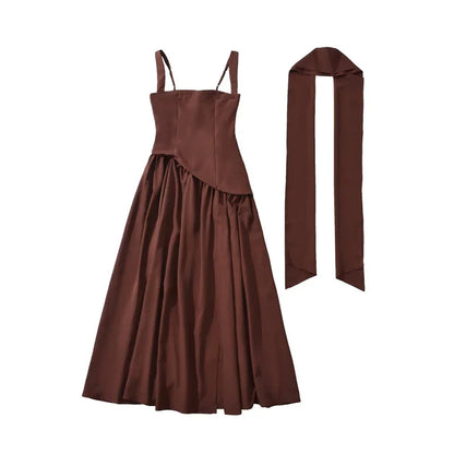 Brown satin slip dress with adjustable straps, asymmetrical hem, and matching long scarf accessory